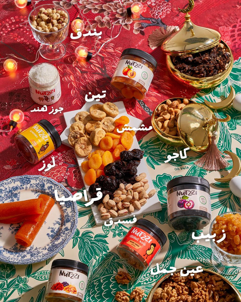 Assorted dried fruits and nuts on a colorful tablecloth with Nutella jars.